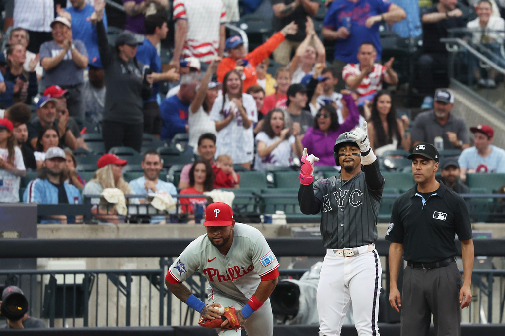 New York Mets' Francisco Lindor, right, gestures after hitting a triple during the sixth inning of a baseball game against the Philadelphia Phillies, Saturday, June 27, 2026, in New York. (AP Photo/Heather Khalifa)