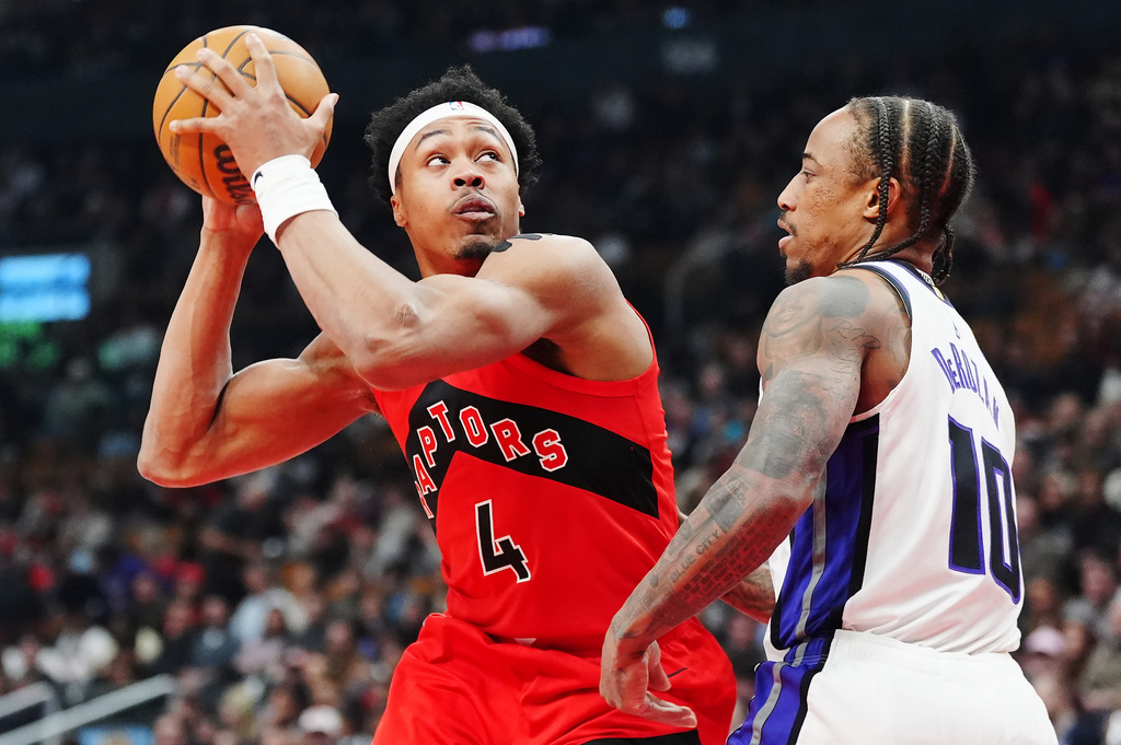 Toronto Raptors' Scottie Barnes (4) protects the ball from Sacramento Kings' DeMar DeRozan (10) during first half of an NBA basketball game in Toronto, Wednesday, April 1, 2026. (Frank Gunn/The Canadian Press via AP)