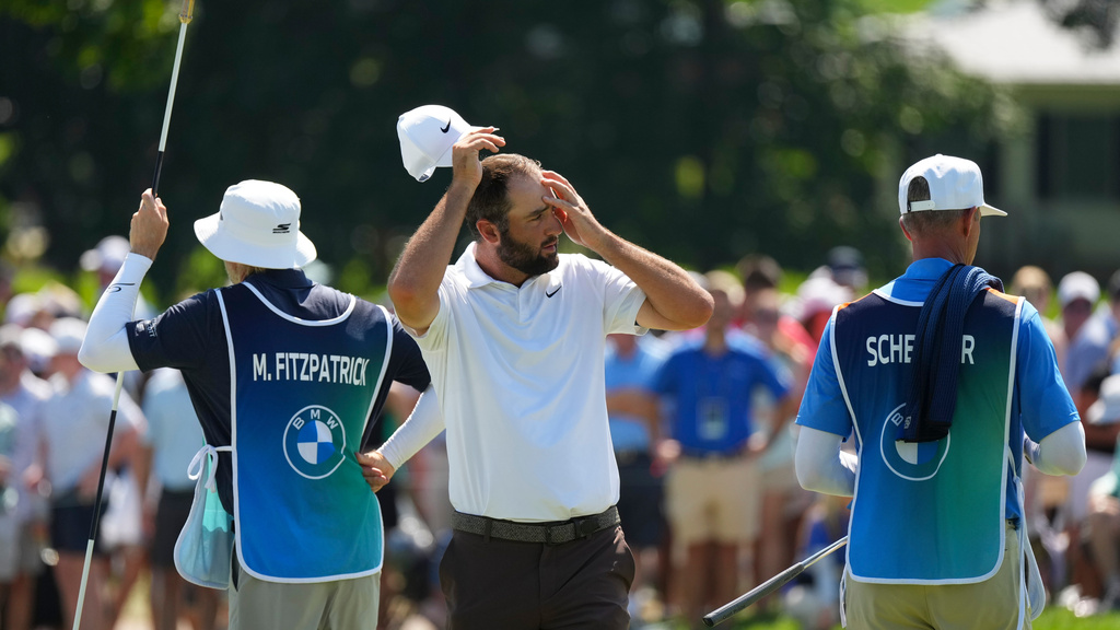 Scottie Scheffler walks off the 18th green during the second round of the BMW Championship golf tournament, Friday, Aug. 21, 2026, in St. Louis. (AP Photo/Jeff Roberson)