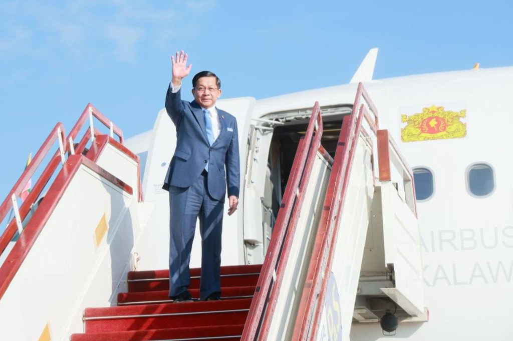 In this photo released by Myanmar President Office, Myanmar President Min Aung Hlaing, waves upon his departure to Malaysia, at the Naypyitaw international airport, in Naypyitaw, Myanmar, Wednesday, Oct. 7, 2026. (Myanmar President Office via AP)