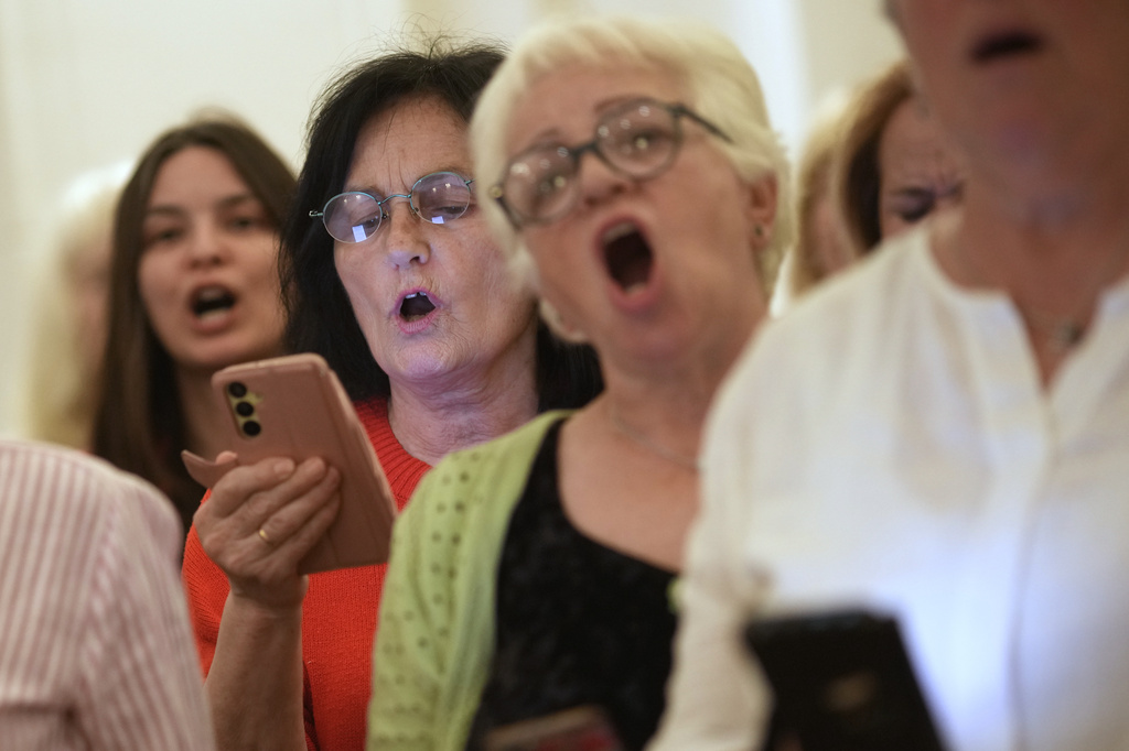 Choir members perform a song during a practice in Belgrade, Serbia, Wednesday, April 15, 2026. (AP Photo/Darko Vojinovic)
