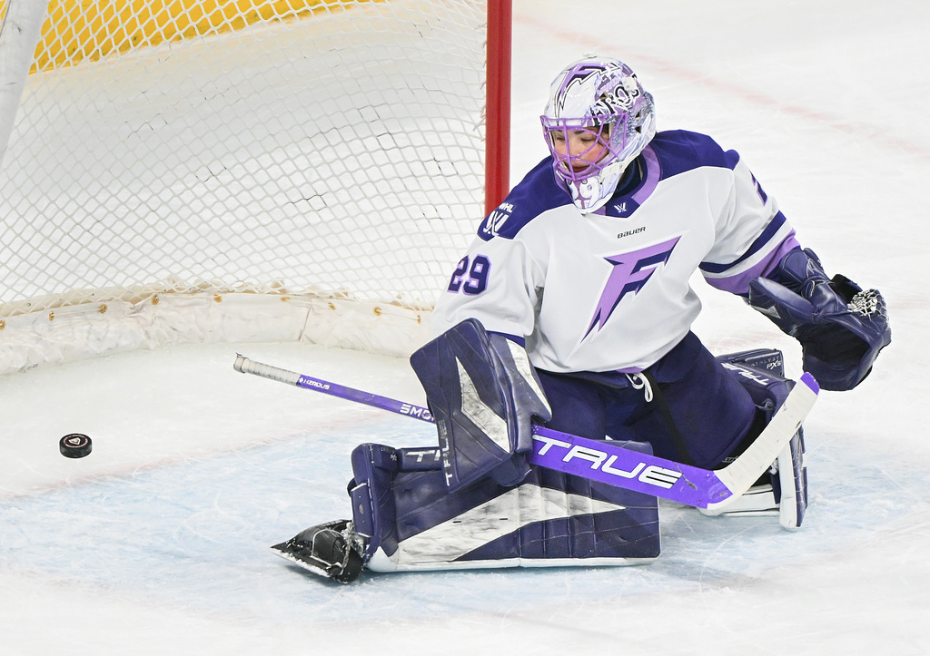 Minnesota Frost goaltender Nicole Hensley is scored against by Montreal Victoire's Maggie Flaherty during first-period PWHL hockey game action in Laval, Quebec, Sunday, March 1, 2026. (Graham Hughes/The Canadian Press via AP)