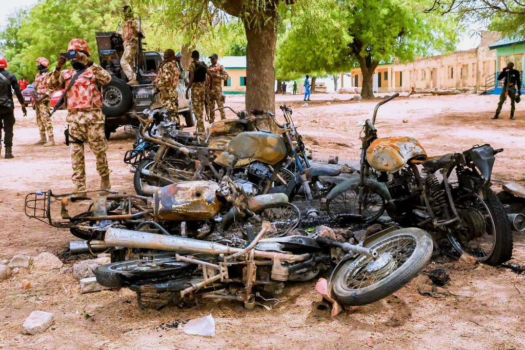 In this photo, released by Adamawa State Government House, a soldier takes photos of burned motorbikes in Guyaku, northeastern Nigeria, Monday, April 27, 2026, following an attack by Militants with the Islamic State group on Sunday. (Adamawa state government house via AP)