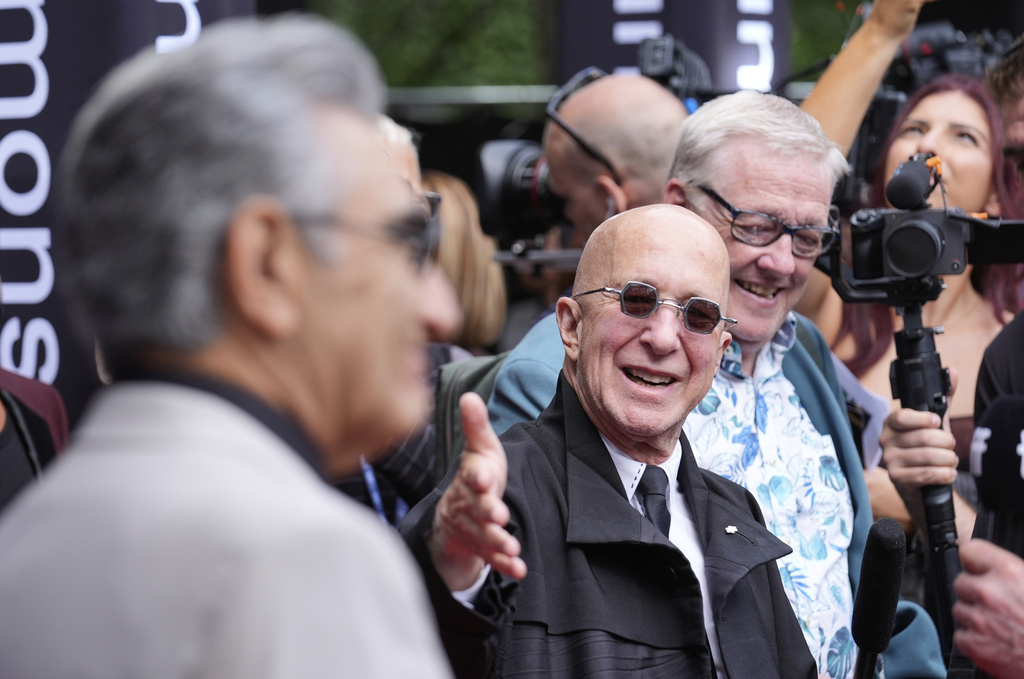 Paul Shaffer, right, reacts as actor Eugene Levy arrives for the premiere "You Had to Be There" during the Toronto International Film Festival in Toronto, Saturday, Sept. 6, 2025. (AP Photo/Chris Pizzello)