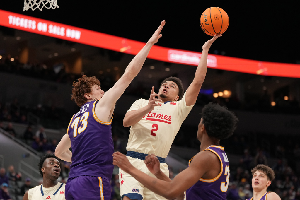 UIC's Elijah Crawford (2) shoots over Northern Iowa's Will Hornseth (13) during the first half of the championship game in the Missouri Valley Conference NCAA college basketball tournament Sunday, March 8, 2026, in St. Louis. (AP Photo/Jeff Roberson)