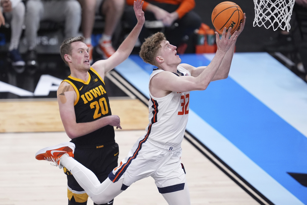 Iowa forward Owen Freeman (32) drives on Iowa forward Payton Sandfort (20) during the second half of an NCAA college basketball game in the second round of the Big Ten Conference tournament in Indianapolis, Thursday, March 13, 2025. (AP Photo/Michael Conroy)