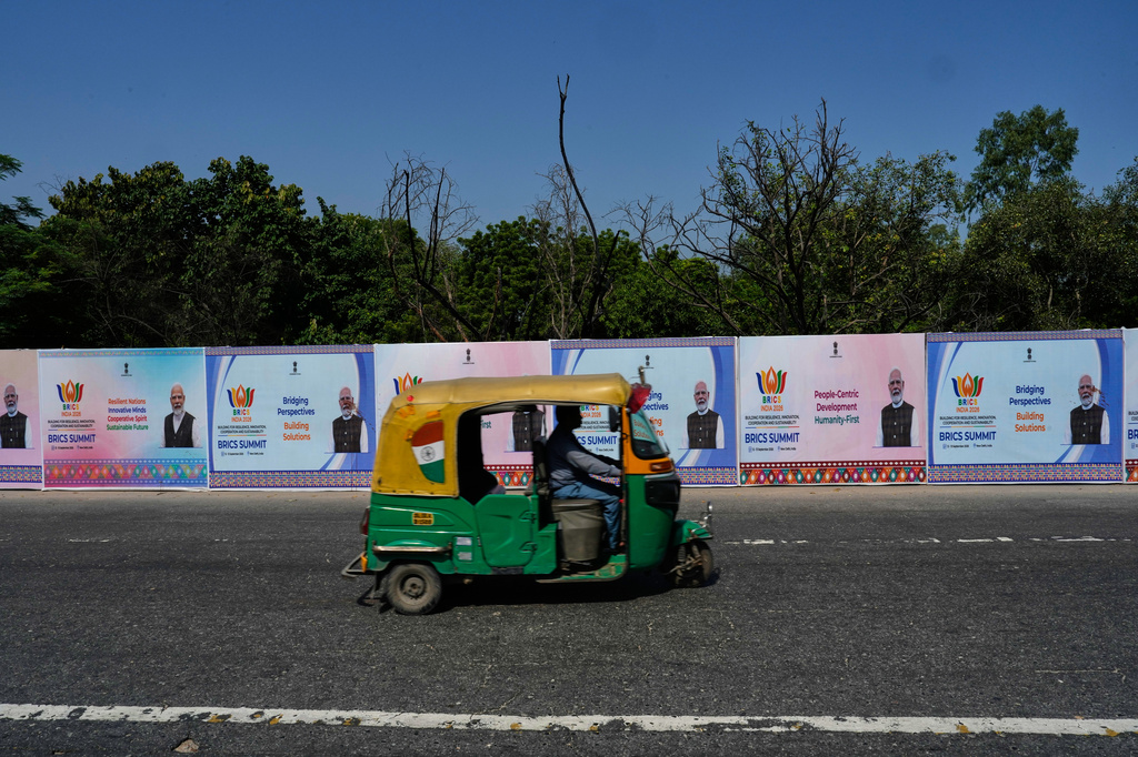 A three-wheeler drives past BRICS summit banners bearing an image of Indian Prime Minister Narendra Modi in New Delhi, India, Thursday, Sept. 10, 2026. (AP Photo/Manish Swarup)