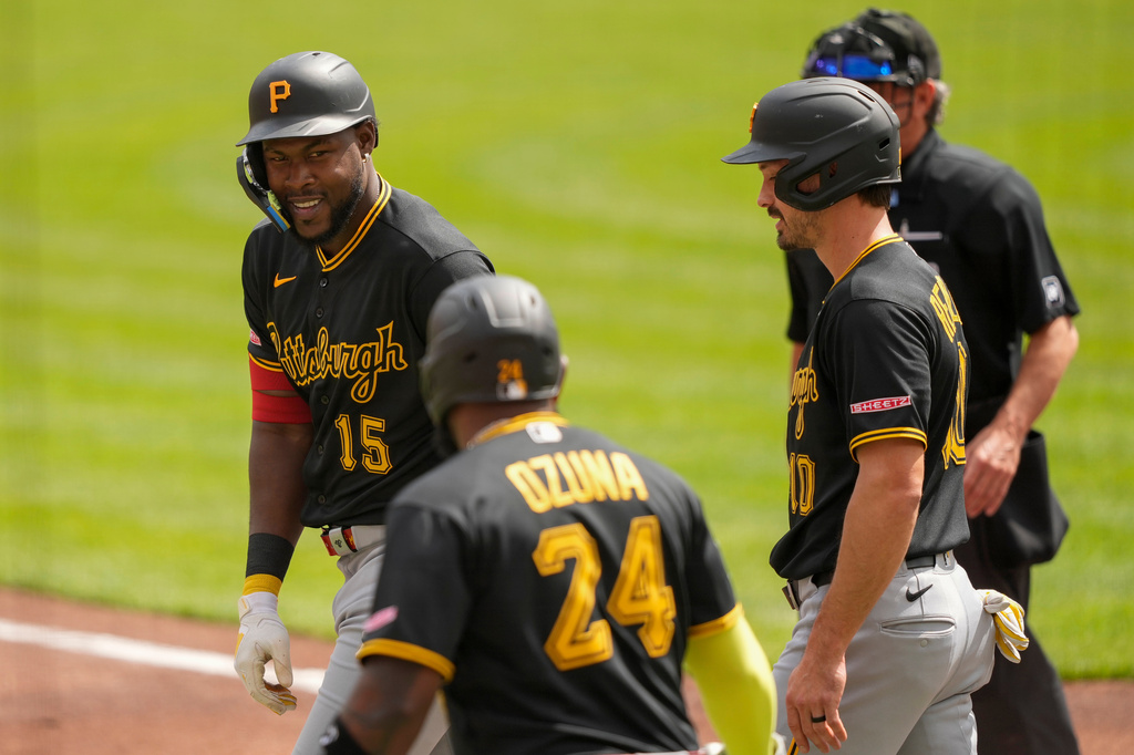 Pittsburgh Pirates' Oneil Cruz, left, Marcell Ozuna, center, and Bryan Reynolds, right, after hitting a three-run homer in the first inning of a baseball game against the Cincinnati Reds in Cincinnati, Wednesday, April 1, 2026. (AP Photo/Carolyn Kaster)