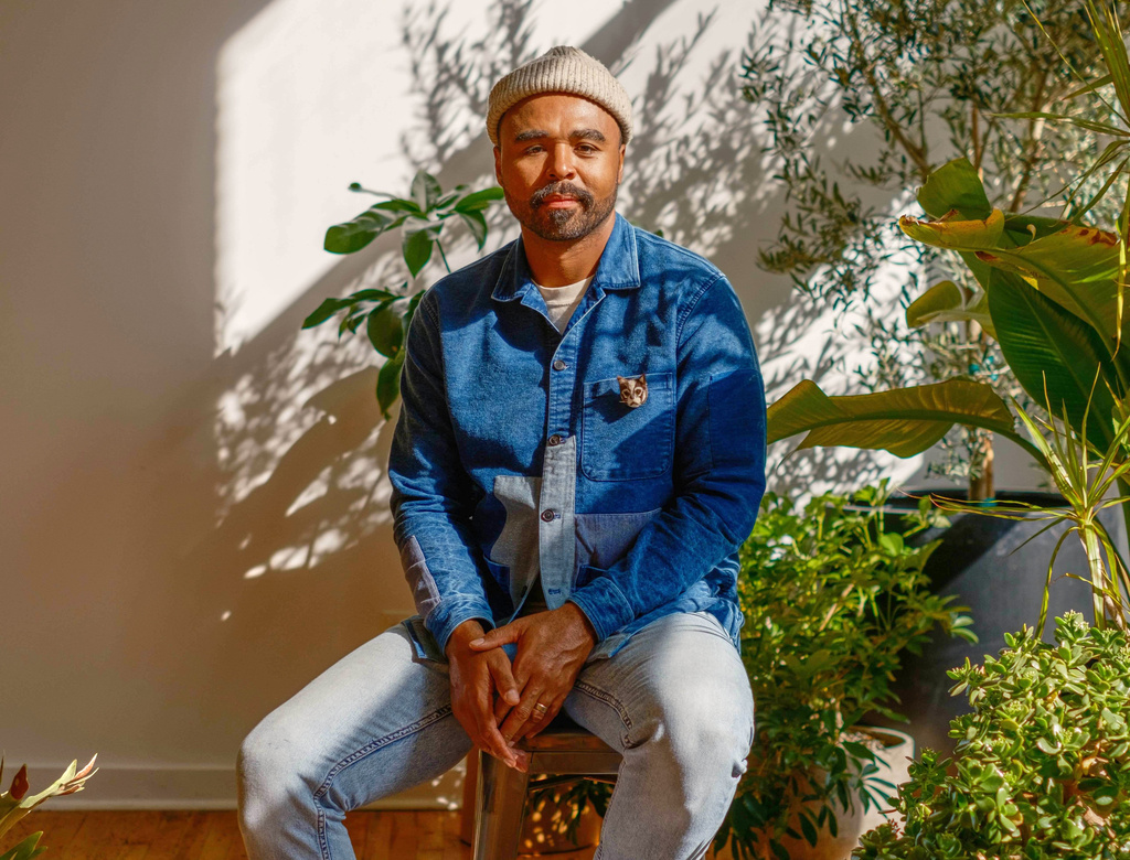 This undated image shows interior and plant stylist Hilton Carter holding at his home in Baltimore. (Ryan Rhodes via AP)