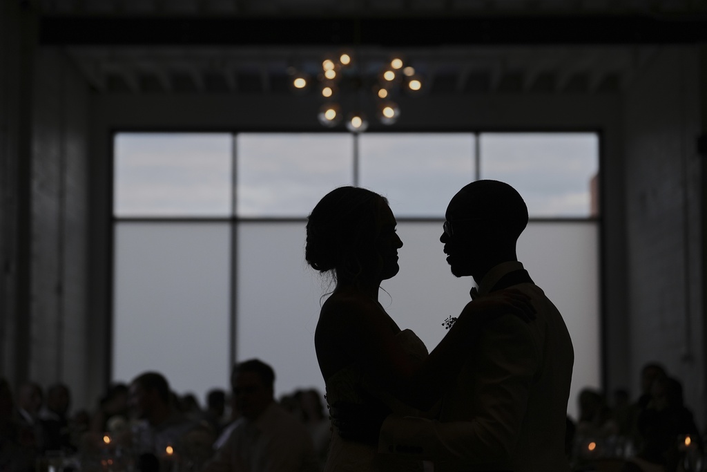 Newlyweds Kayla McDonald, left, and Tyler Jones, right, dance during their wedding reception Saturday, Aug. 23, 2025, in Newtown, Ohio. (AP Photo/Joshua A. Bickel)