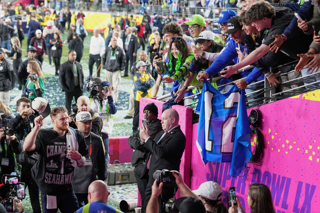 Seattle Seahawks quarterback Sam Darnold, left, celebrates as he walks off the field after winning the NFL Super Bowl 60 football game against the New England Patriots, Sunday, Feb. 8, 2026, in Santa Clara, Calif. (AP Photo/Godofredo A. Vásquez)
