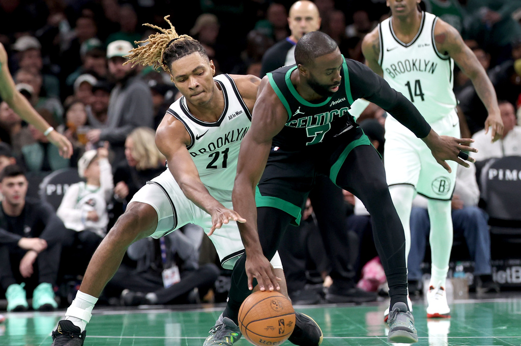 Boston Celtics forward Jaylen Brown (7) defends the ball from Brooklyn Nets forward Noah Clowney (21) during the second half of an NBA Cup basketball game, Friday, Nov. 21, 2025, in Boston. (AP Photo/Mark Stockwell)