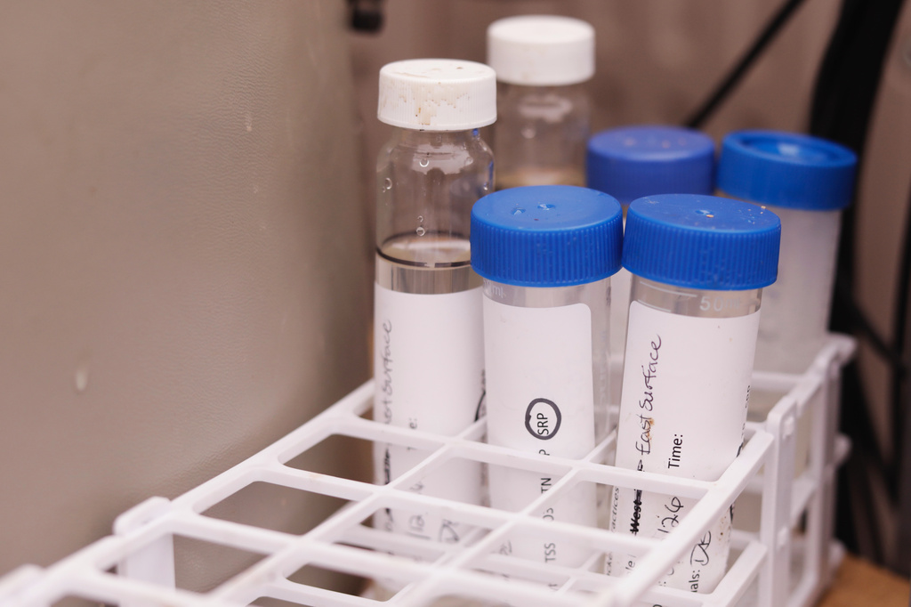 Runoff samples from two agricultural fields to be analyzed for nutrient concentrations sit in holders on Thursday, March 12, 2026, in Bridport, Vt. (AP Photo/Amanda Swinhart)