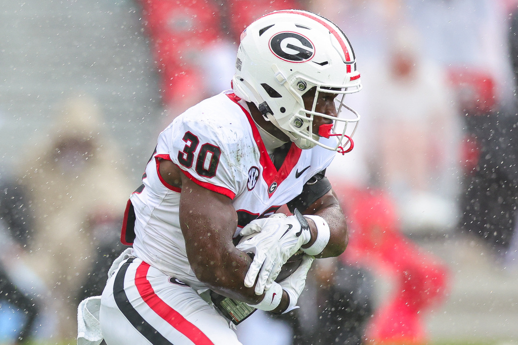 Georgia running back Nick Peal (30) runs with the ball during the second half of an NCAA college football game against Western Kentucky, Saturday, Sept. 12, 2026, in Athens, Ga. (AP Photo/Colin Hubbard)