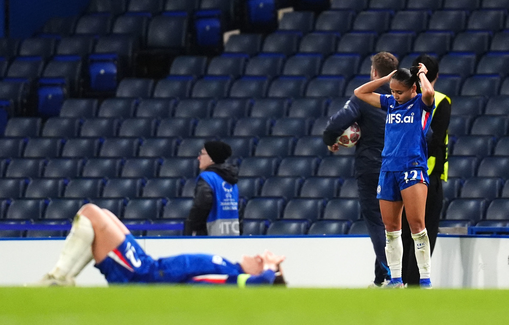 Chelsea's Alyssa Thompson, right, and a teammate react following defeat in the Women's Champions League quarterfinal second leg soccer match against Arsenal in London, Wednesday, April 1, 2026. (John Walton/PA via AP)
