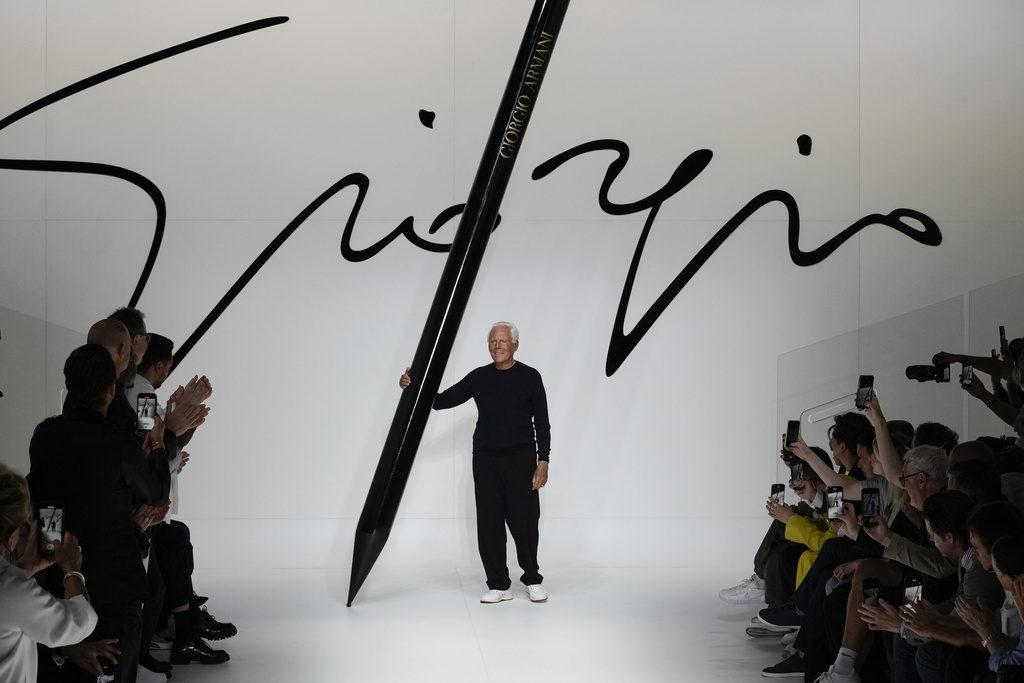 FILE -Designer Giorgio Armani receives applause at the end of the Giorgio Armani men's Spring Summer 2024 fashion show presented in Milan, Italy,, June 19, 2023. (AP Photo/Luca Bruno, File)