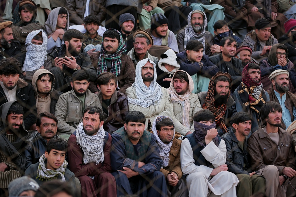 Afghan men attend the final of Afghanistan's annual buzkashi tournament, a traditional equestrian sport in which riders compete to score points using a fake goat carcass, on the outskirts of Kabul, Afghanistan, Monday, Dec. 22, 2025. (AP Photo)