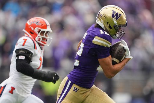 Washington wide receiver Denzel Boston (12) runs the ball against Illinois defensive back Matthew Bailey (7) during the first half of NCAA college football game, Saturday, Oct. 25, 2025, in Seattle. (AP Photo/Lindsey Wasson) Washington wide receiver Denzel Boston (12) runs the ball against Illinois defensive back Matthew Bailey (7) during the first half of NCAA college football game, Saturday, Oct. 25, 2025, in Seattle. (AP Photo/Lindsey Wasson)
