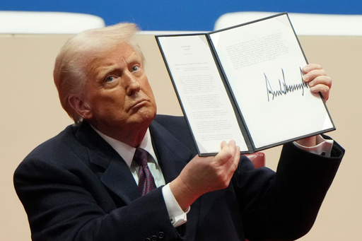 FILE - President Donald Trump holds up an executive order after signing it at an indoor Presidential Inauguration parade event in Washington, Jan. 20, 2025. (AP Photo/Matt Rourke, File) FILE - President Donald Trump holds up an executive order after signing it at an indoor Presidential Inauguration parade event in Washington, Jan. 20, 2025. (AP Photo/Matt Rourke, File)