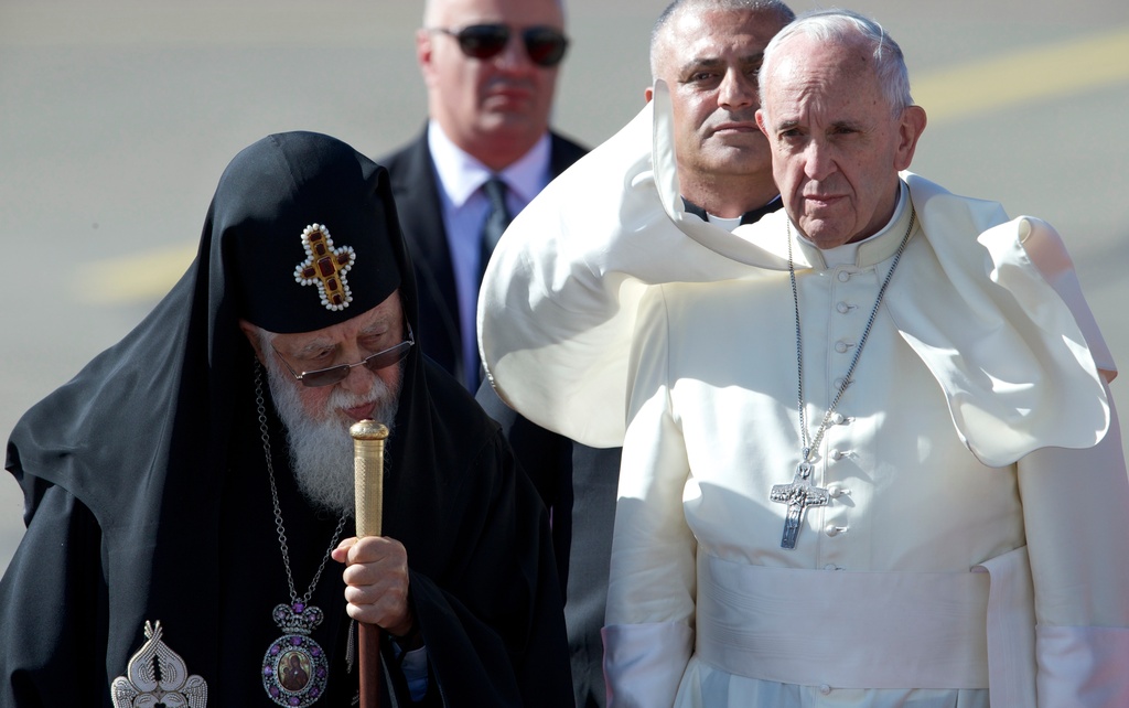 FILE - Pope Francis and Georgian Orthodox Patriarch Ilia II, left, attend a welcoming ceremony shortly upon his landing in Tbilisi, Georgia, on Friday, Sept. 30, 2016. (AP Photo/Ivan Sekretarev, File)