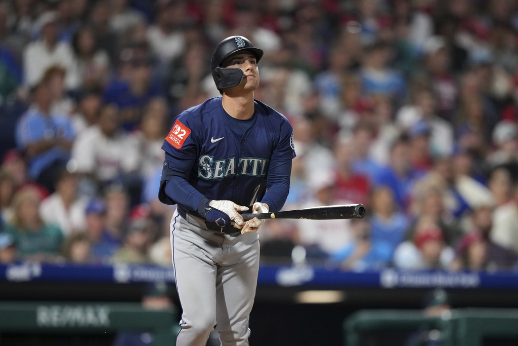 Seattle Mariners' Cole Young watches after hitting a three-run home run against Philadelphia Phillies pitcher Jordan Romano during the seventh inning of a baseball game Monday, Aug. 18, 2025, in Philadelphia. (AP Photo/Matt Slocum)