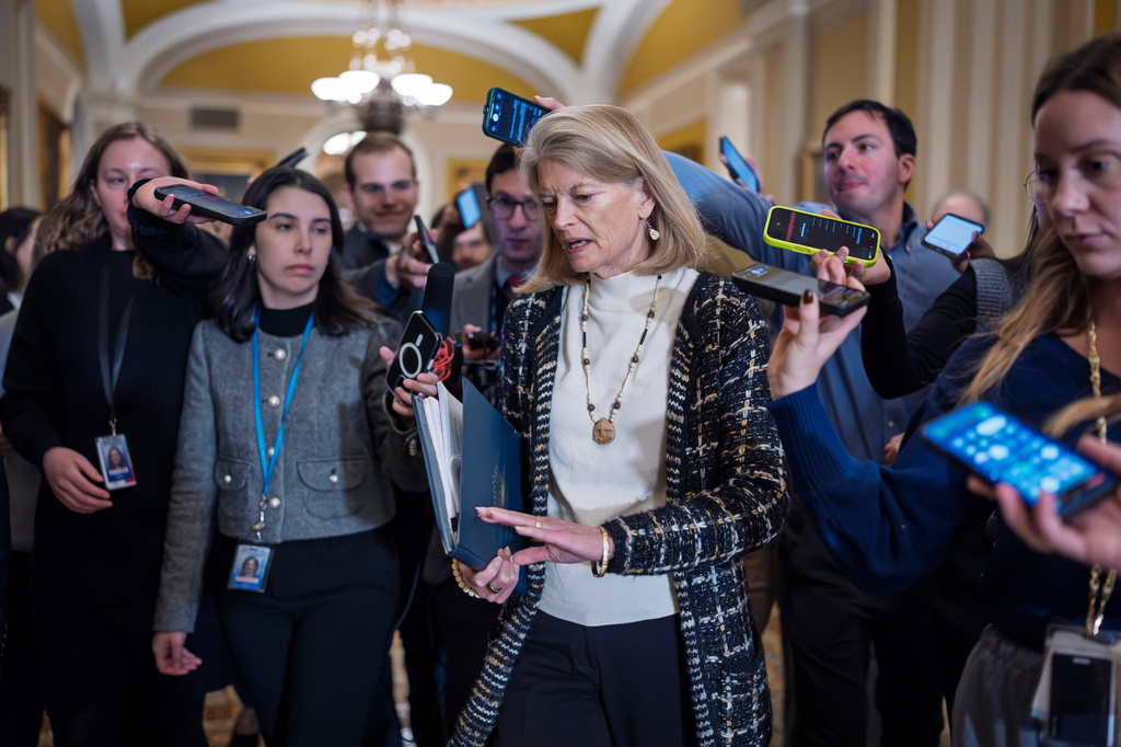 With a partial government shutdown looming by week's end, Sen. Lisa Murkowski, R-Alaska, a member of the Senate Appropriations Committee, is surrounded by reporters following a closed-door Republican meeting on spending legislation that funds the Department of Homeland Security and a swath of other government agencies as the country reels from the deaths of two people at the hands of federal agents in Minneapolis, at the Capitol in Washington, Wednesday, Jan. 28, 2026. (AP Photo/J. Scott Applewhite)