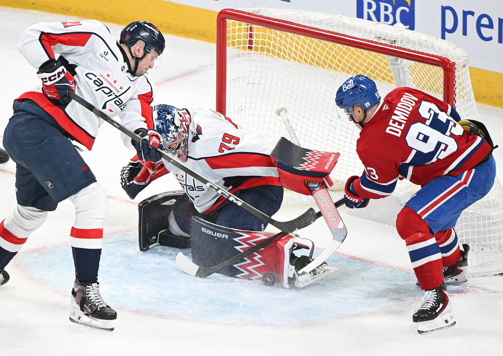 Washington Capitals goaltender Charlie Lindgren (79) stops Montreal Canadiens' Ivan Demidov (93) as Capitals' Aliaksei Protas (21) defends during the second period of an NHL hockey game in Montreal, Saturday, Feb. 28, 2026. (Graham Hughes/The Canadian Press via AP)
