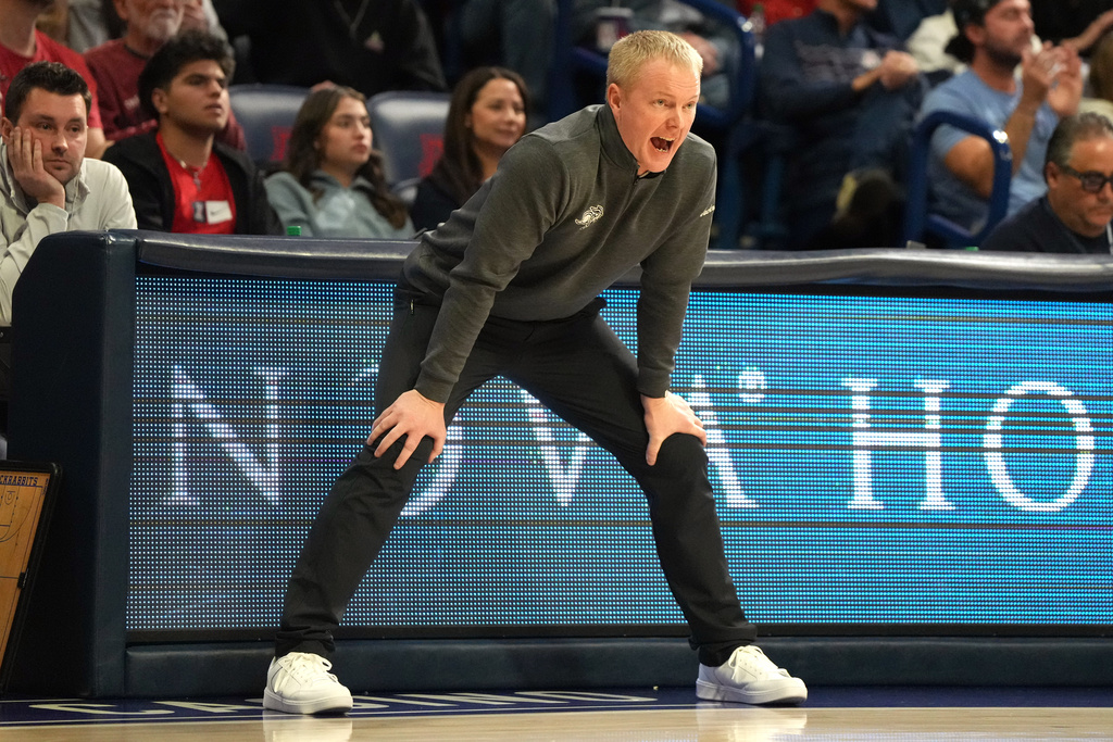 South Dakota State head coach Bryan Peterson reacts after a foul against Arizona during the first half of an NCAA college basketball game, Monday, Dec. 29, 2025, in Tucson, Ariz. (AP Photo/Rick Scuteri)