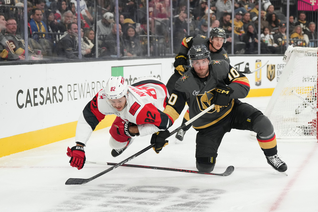 FILE - Carolina Hurricanes center Jesperi Kotkaniemi (82) collides with Vegas Golden Knights center Colton Sissons (10) during the second period of an NHL hockey game, Oct. 20, 2025, in Las Vegas. (AP Photo/Candice Ward, file)