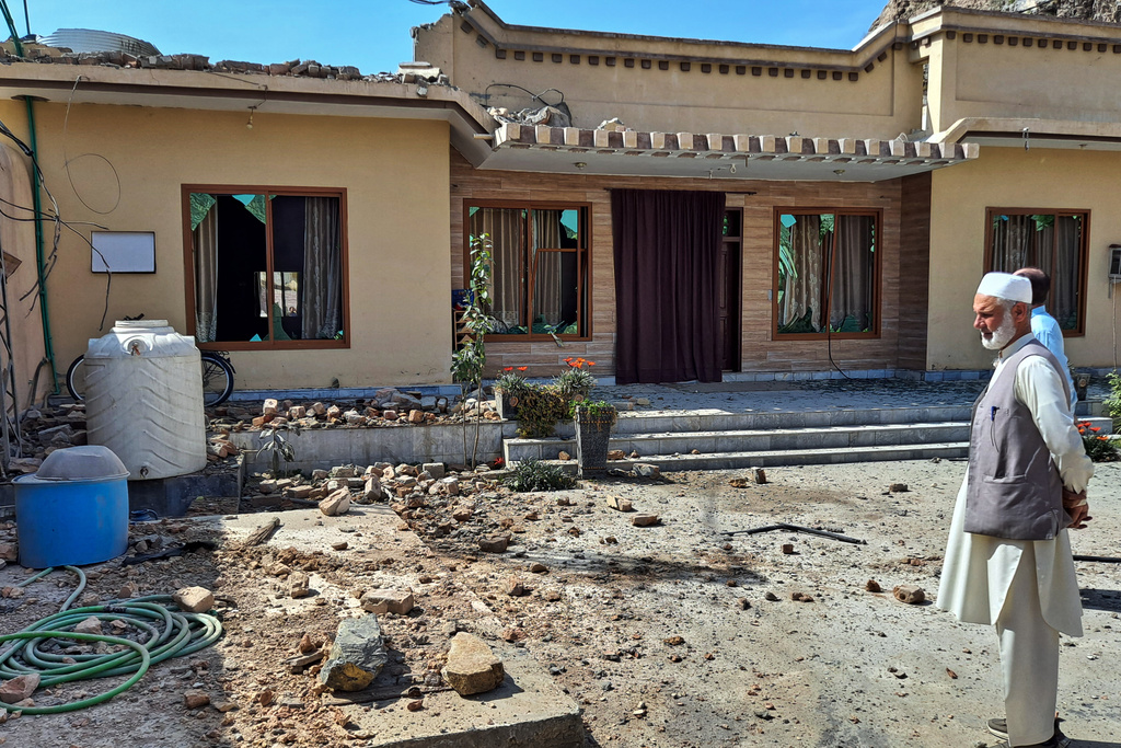 Local residents examine damages to their house due to mortar shell fired by Afghan forces, at a village in Khyber, a district of Pakistan's Khyber Pakhtunkhwa province bordering with Afghanistan, Thursday, March 5, 2026. (AP Photo/S.B. Shah)