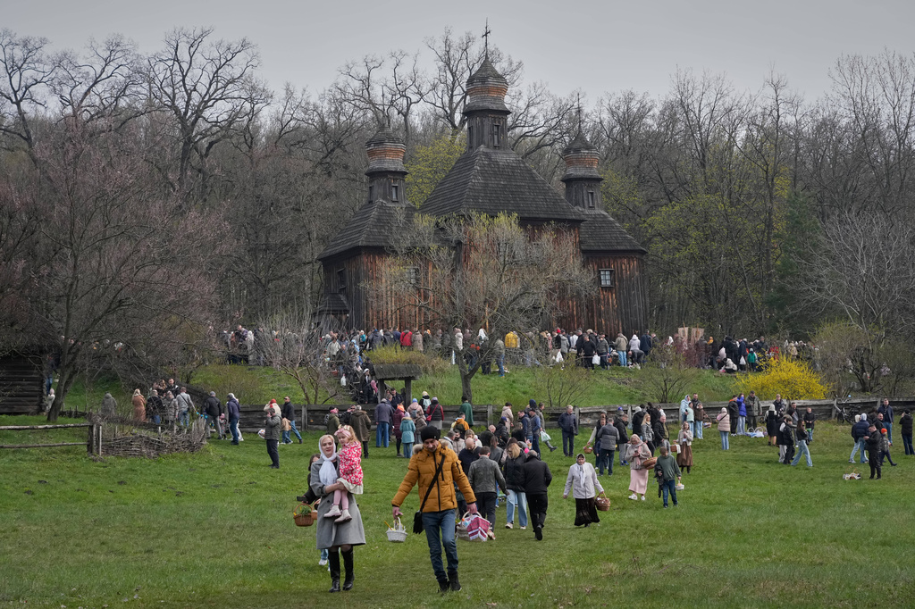 People carry their Easter baskets as they leave an old church to mark Orthodox Easter, in Pyrohiv, close to Kyiv, Ukraine, Sunday, April 12, 2026. (AP Photo/Efrem Lukatsky)