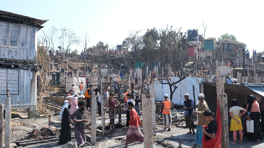 CORRECTING NAME OF PHOTOGRAPHER- People stand near the site of a fire that broke out in Camp 16, one of more than 30 Rohingya refugee camps in the Cox's Bazar district, Bangladesh, Tuesday, Jan. 20, 2026. (Ratul Piul, Norwegian Refugee Council via AP)