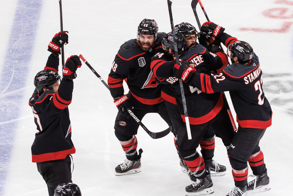 The Carolina Hurricanes players celebrate after the winning goal by Hurricanes' Seth Jarvis (24) against the Vegas Golden Knights during overtime in Game 2 of the NHL hockey Stanley Cup Final series in Raleigh, N.C., Thursday, June 4, 2026. (AP Photo/Ben McKeown)