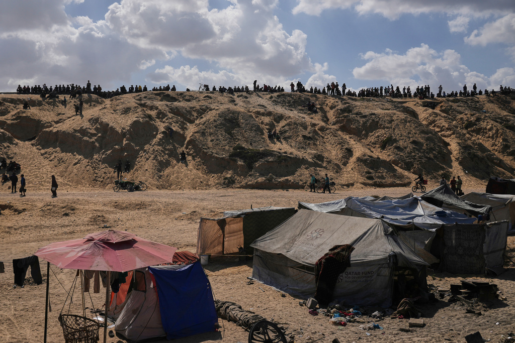 Displaced Palestinians walk along the coastal road near Wadi Gaza in the central Gaza Strip, moving toward northern Gaza, Friday, Oct. 10, 2025, after Israel and Hamas have agreed to a pause in their war and the release of the remaining hostages. (AP Photo/Abdel Kareem Hana)