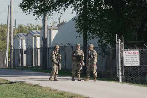 Military personnel in uniform, with the Texas National Guard patch on, are seen at the U.S. Army Reserve Center, Wednesday, Oct. 8, 2025, in Elwood, Ill., a suburb of Chicago. (AP Photo/Laura Bargfeld) Military personnel in uniform, with the Texas National Guard patch on, are seen at the U.S. Army Reserve Center, Wednesday, Oct. 8, 2025, in Elwood, Ill., a suburb of Chicago. (AP Photo/Laura Bargfeld)