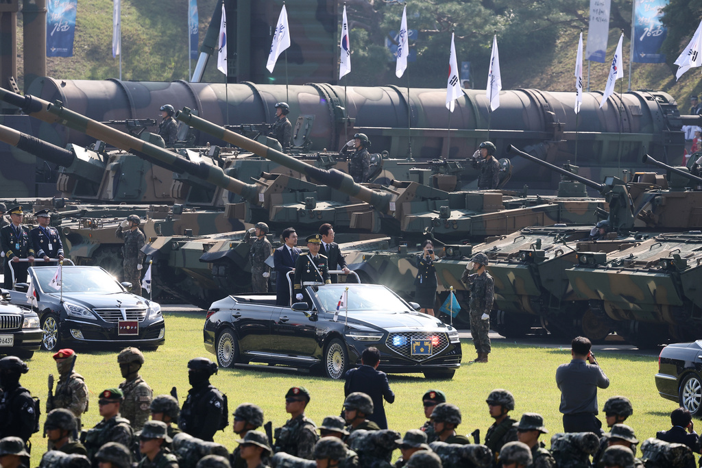 South Korean President Lee Jae Myung, center right, and Defense Minister Ahn Gyu-back, center left, inspect military assets during a celebration to mark 77th Armed Forces Day in Gyeryong, South Korea Wednesday, Oct. 1, 2025. (Kim Hong-Ji/Pool Photo via AP)