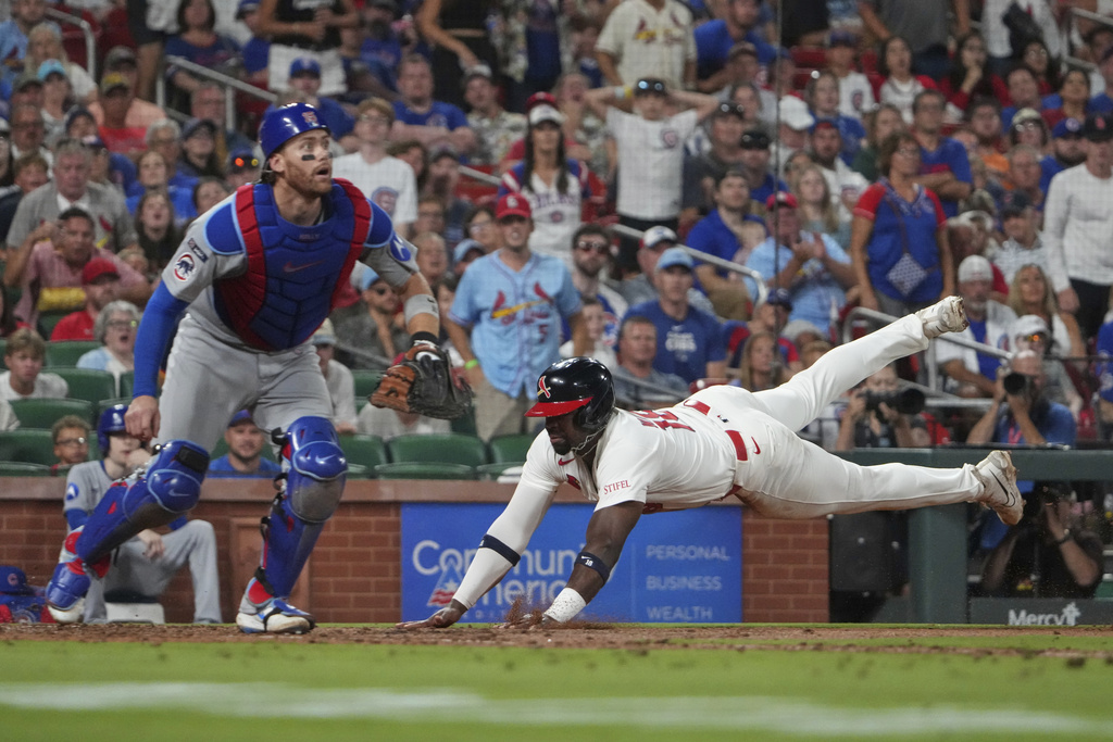 St. Louis Cardinals' Jordan Walker, right, scores past Chicago Cubs catcher Carson Kelly during the seventh inning of a baseball game Sunday, Aug. 10, 2025, in St. Louis. (AP Photo/Jeff Roberson)