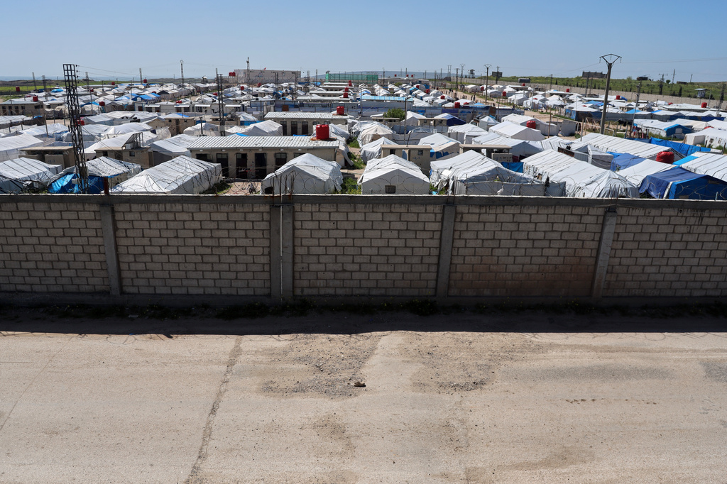 A brick wall surrounds a tent camp housing people with alleged ties to Islamic State militants at Roj Camp in eastern Syria, Friday, April 24, 2026. (AP Photo/Baderkhan Ahmad)