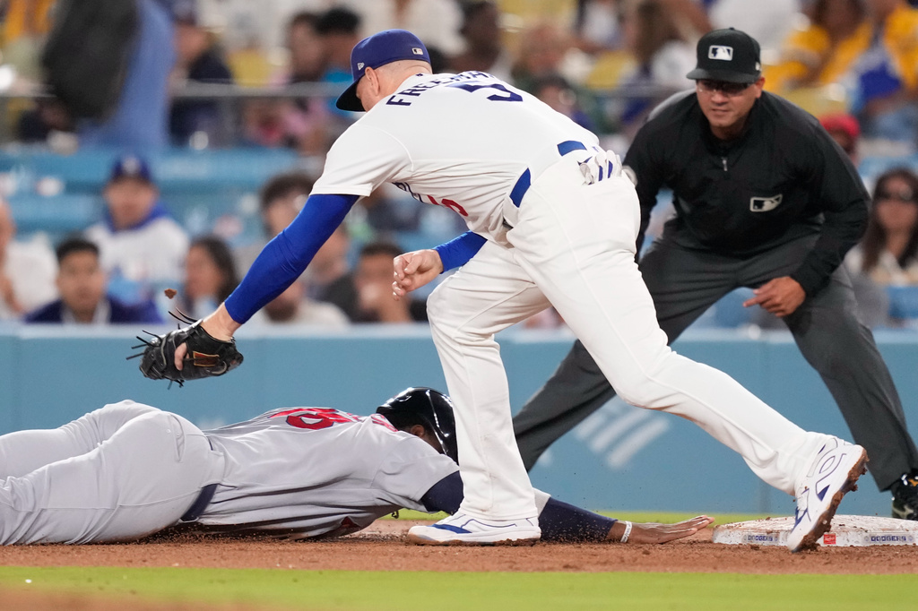 St. Louis Cardinals' Jordan Walker, left, is tagged out at first by Los Angeles Dodgers first baseman Freddie Freeman after being caught off base during the fifth inning of a baseball game Thursday, Sept. 3, 2026, in Los Angeles. (AP Photo/Mark J. Terrill)