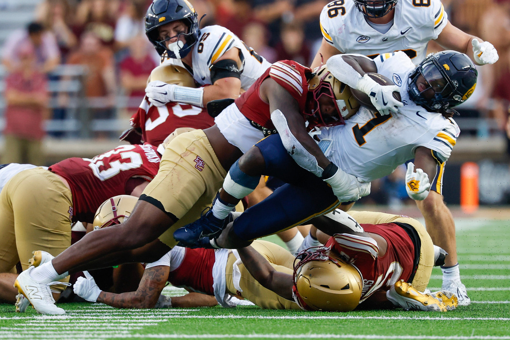 FILE - California running back Kendrick Raphael (1) is tackled by Boston College linebacker Bryce Steele (8) during the second half of an NCAA football game on Saturday, Sept. 27, 2025, in Chestnut Hill, Mass. (AP Photo/Greg M. Cooper, File)