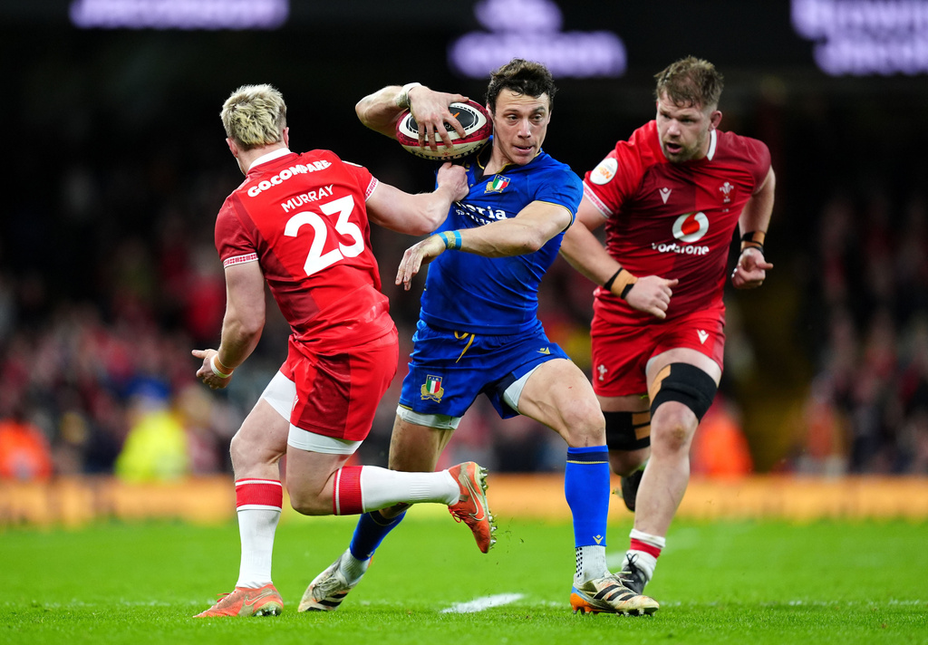 Italy's Paolo Garbisi evades Wales' Blair Murray during the Men's Six Nations match between Wales and Italy in Cardiff, Wales, Saturday March 14, 2026. (David Davies/PA via AP)