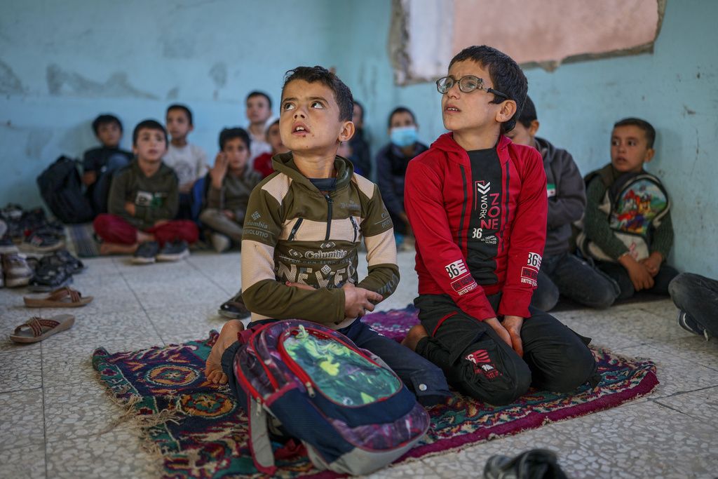 Students attend a lesson inside a classroom of the Maar Shmarin Primary School in the village of Maar Shmarin, in the Idlib countryside, Syria, Sunday, Oct. 19, 2025. (AP Photo/Ghaith Alsayed)