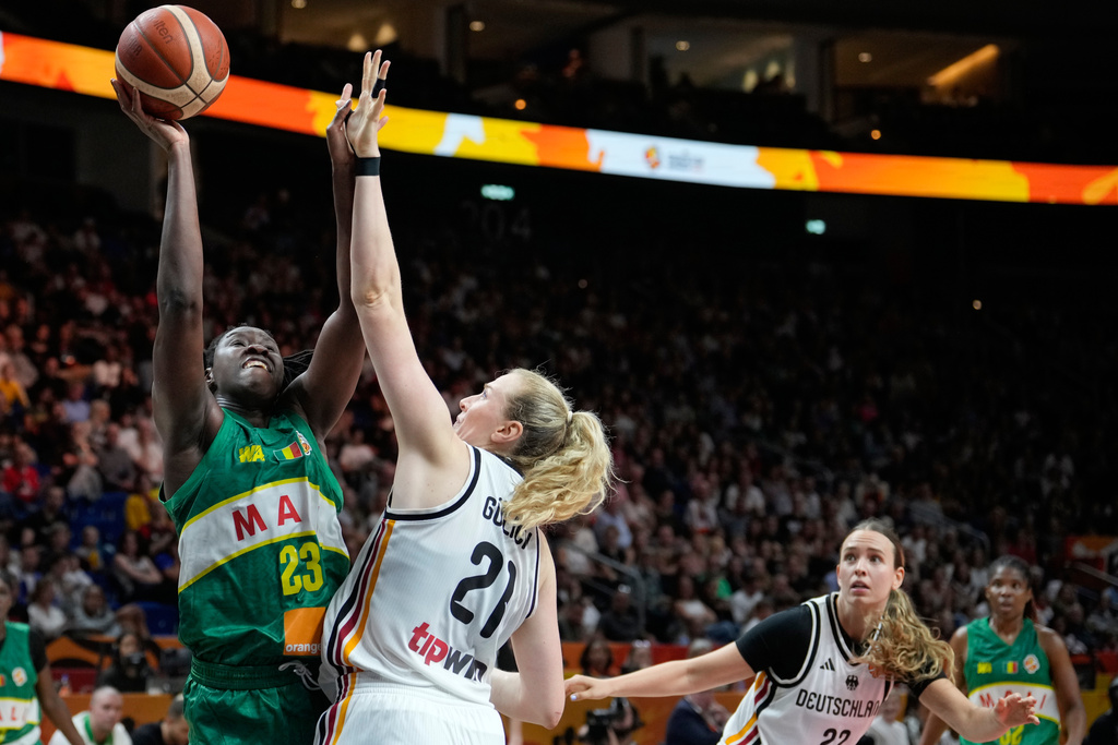 Mali's Sika Kone shoots over Germany's Marie Guelich during the Women's Basketball World Cup match between the Germany and Mali in Berlin, Monday, Sept. 7, 2026. (AP Photo/Ebrahim Noroozi)