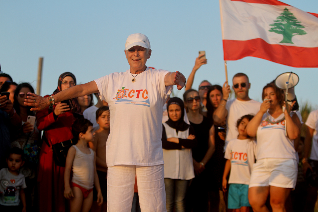 Mona Khalil, a Lebanese conservationist who died on Friday after being wounded in an Israeli strike on her home on Lebanon's southern coast, gestures during a event of releasing baby sea turtles in Mansouri village near Tyre city, south Lebanon, July 31, 2019. (AP Photo/Hussein Malla)