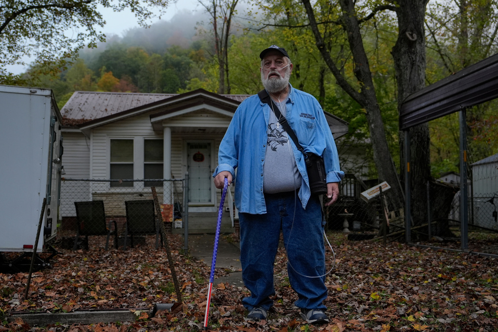 Randy Lawrence, president of the Kanawha County Black Lung Association, stands outside his home wearing supplemental oxygen for black lung disease near Cabin Creek, W.Va., Oct. 13, 2025. (AP Photo/Carolyn Kaster)