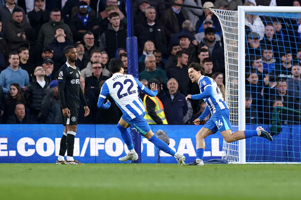 Brighton and Hove Albion's Ferdi Kadioglu, right, celebrates scoring their side's first goal during the English Premier League soccer match between Brighton & Hove Albion and Chelsea in Brighton, England, Tuesday, April 21, 2026. (Gareth Fuller/PA via AP)