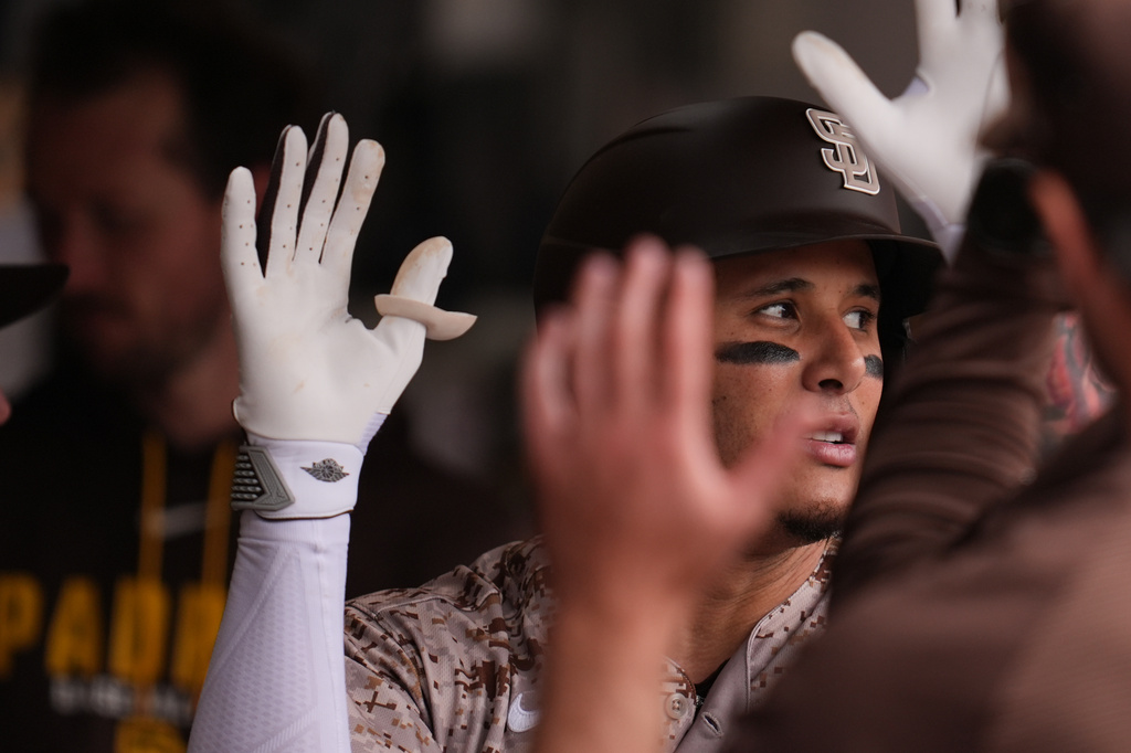 San Diego Padres' Manny Machado celebrates his home run with teammates during the fourth inning of a baseball game against the Chicago White Sox Sunday, May 3, 2026, in San Diego. (AP Photo/Gregory Bull)