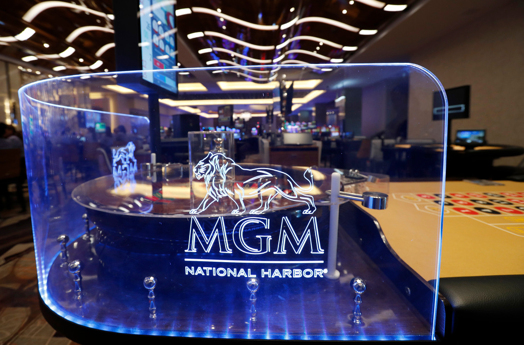 FILE - The MGM National Harbor logo is seen around a roulette wheel in the casino during a preview tour of the MGM National Harbor, Dec. 2, 2016 in Oxon Hill, Md. (AP Photo/Alex Brandon, File)