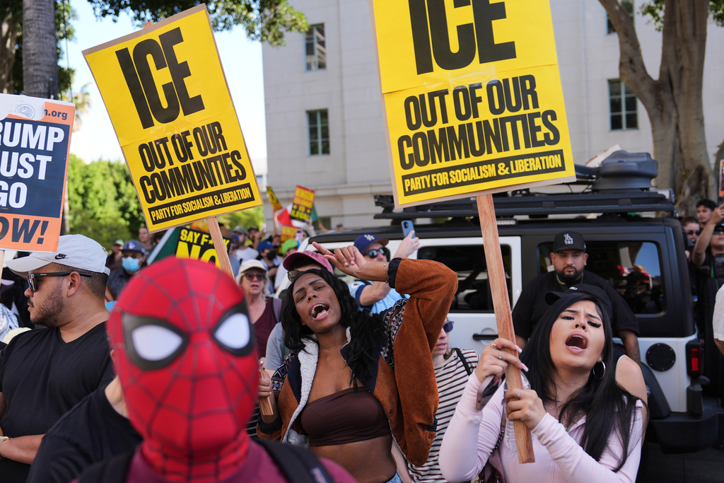 People gather during a protest on Friday, Jan. 30, 2026, in Los Angeles. (AP Photo/Jae C. Hong)