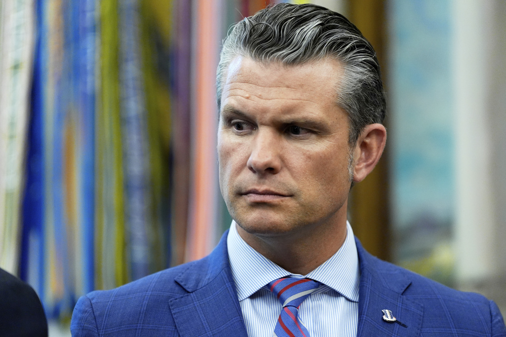 Defense Secretary Pete Hegseth listens as President Donald Trump speaks in the Oval Office of the White House, Monday, Sept. 15, 2025, in Washington. (AP Photo/Alex Brandon)